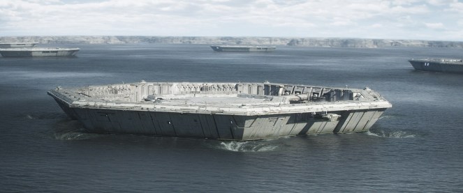 A large, futuristic, octagonal structure floating on water, surrounded by cloudy skies and distant land formations.
